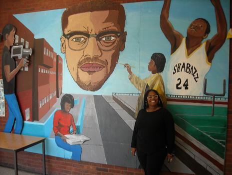 Teacher Lauretta Crawford poses in front of a mural at Malcolm X Shabazz High School. Teacher Lauretta Crawford poses in front of a mural at Malcolm X Shabazz High School.